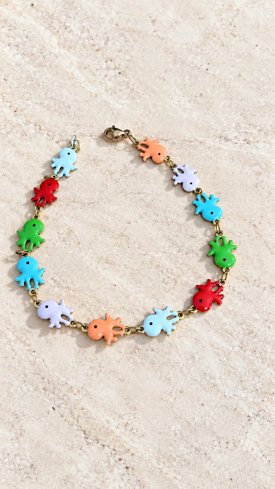 Dodici polpi colorati collegati da anellini, con chiusura a moschettone. Proposta di collezione: materiali, misure ed età di utilizzo ancora da definire.